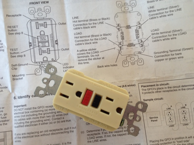 Old GFCI outlet removed from my wall with instructions for installing the replacement outlet.